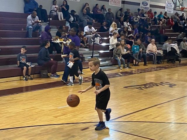 Youth player dribbling with crowd in bleachers